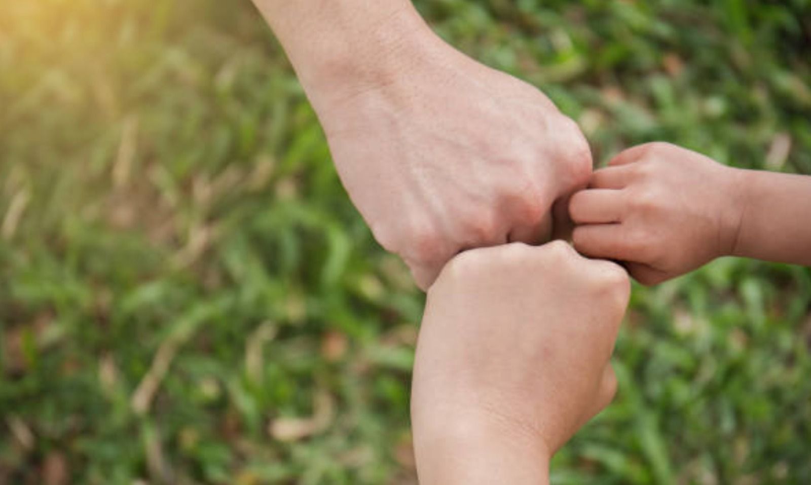 Padres chocando la manos con su hijo
