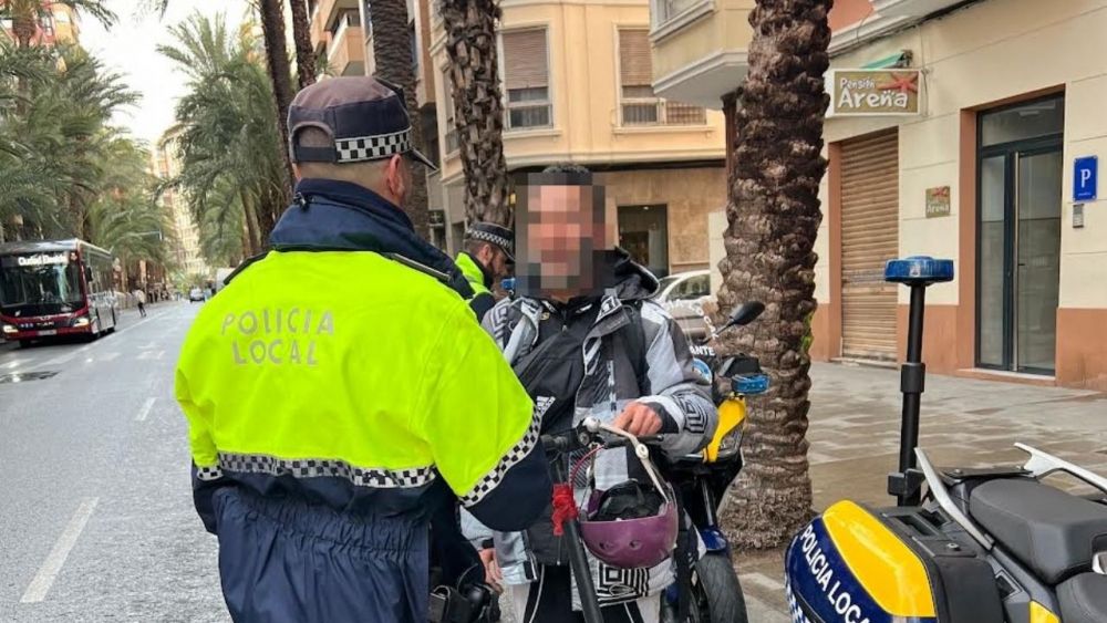 Un agente pone una multa a una persona con un patinete eléctrico Un agente pone una multa a una persona con un patinete eléctrico